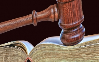wooden gavel atop old book
