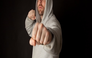 Man in hodded jumper fighting pose